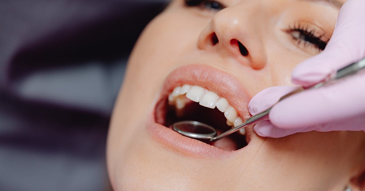 close up of a patient getting a dental checkup with dental tools in use